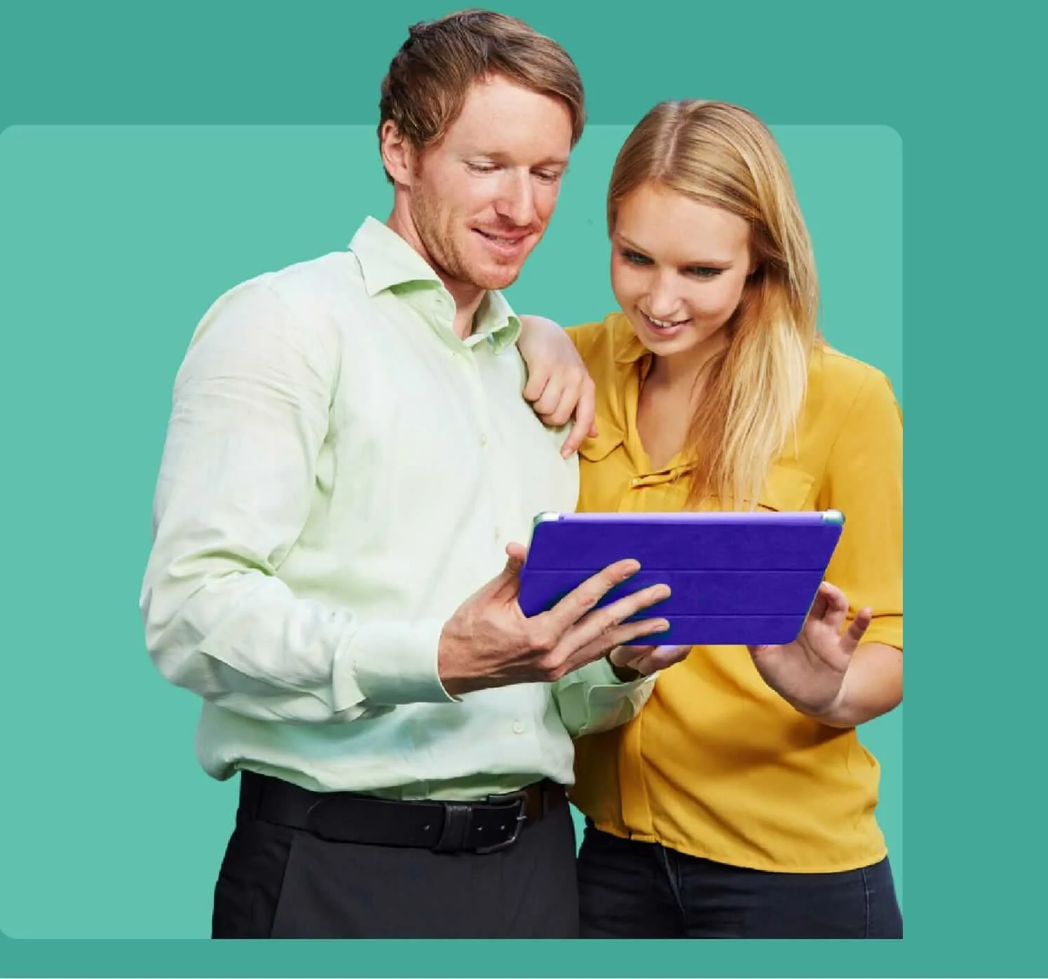 A man and woman looking at a tablet together, smiling.