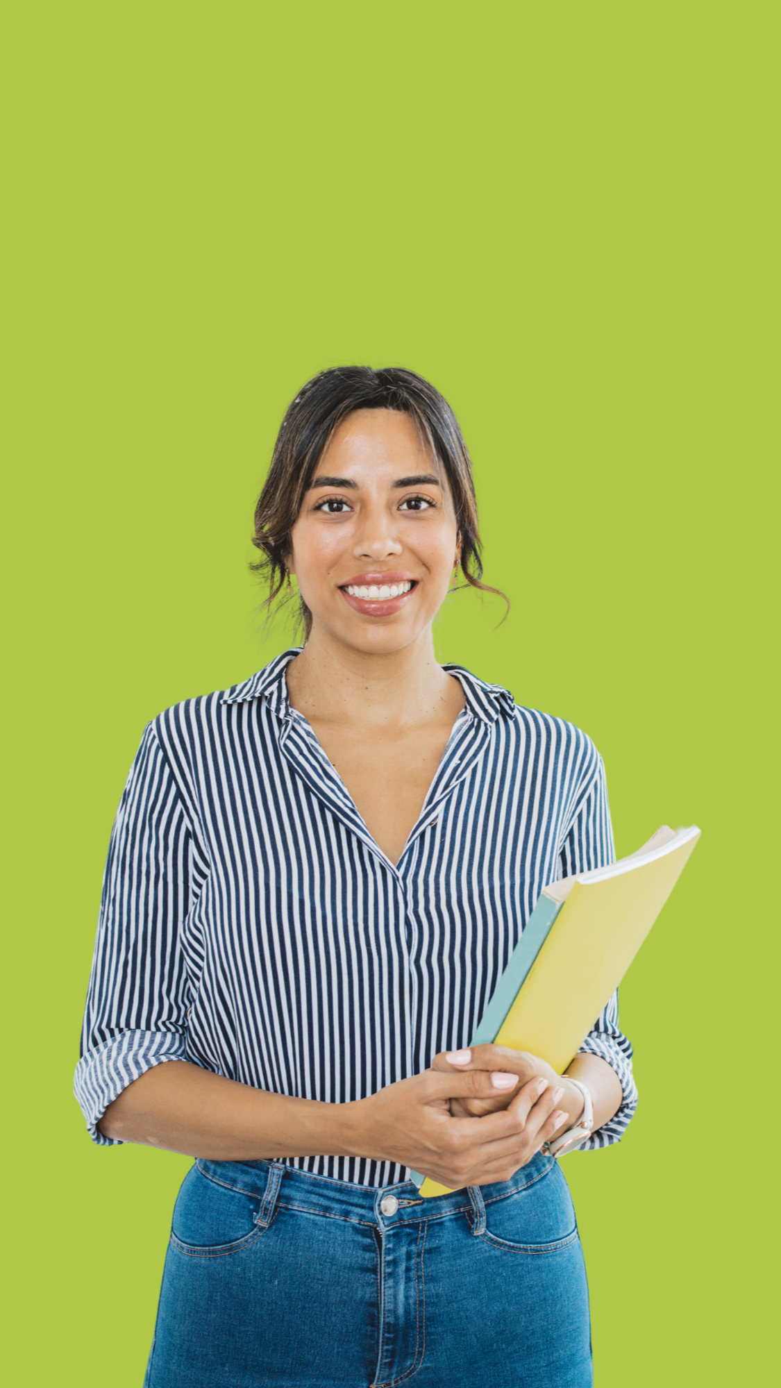 Smiling woman with dark hair holding yellow and blue notebooks in front of a solid green background.