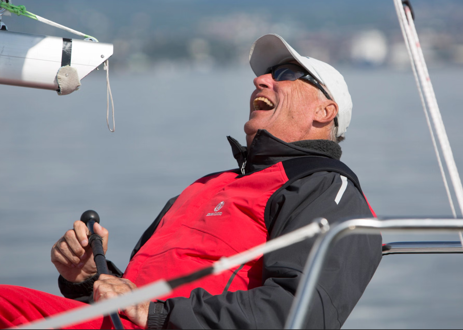 King Haralad V of Norway happy on sailboat
