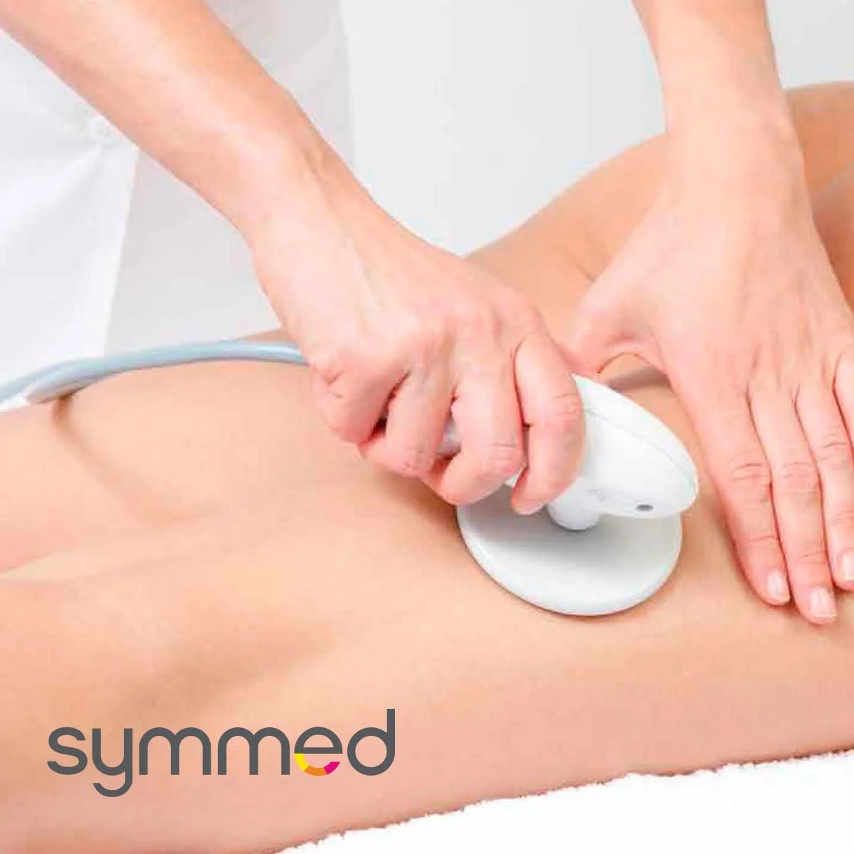 A person receiving a massage or physical therapy using a therapeutic device on their lower back.