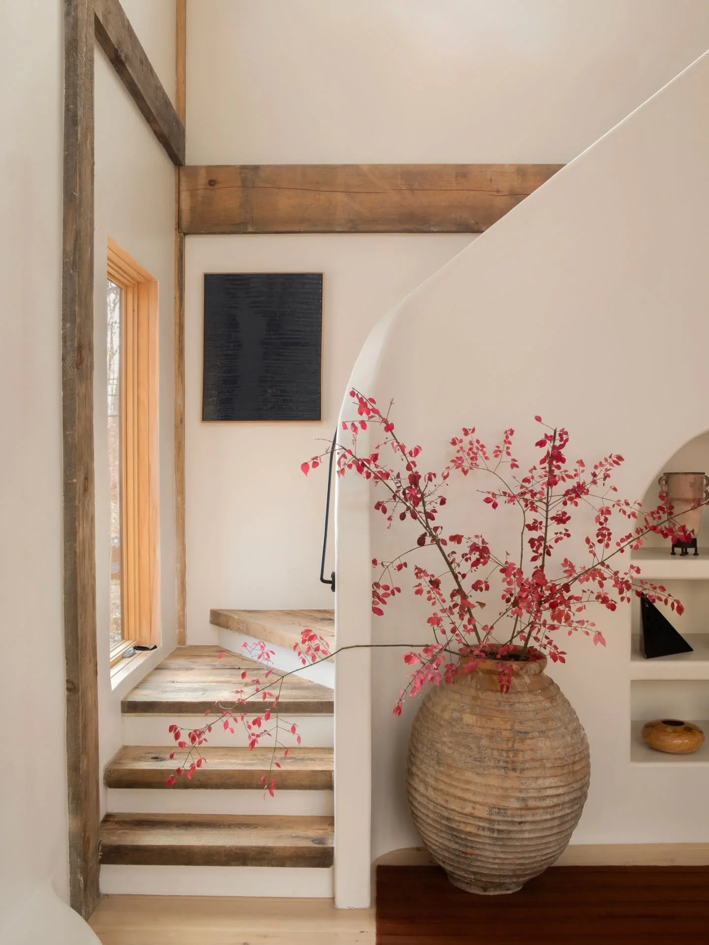 In this quiet sanctuary, the morning light filters through, casting a soft glow over the sculpted curves of the home. Every element, from the original timber beams to the tactile weave of the rugs, serve as a gentle reminder to breathe, slow down, an