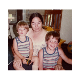 Randy with his biological brother, Wesley, on their adoption day. We don't know the woman in the picture.