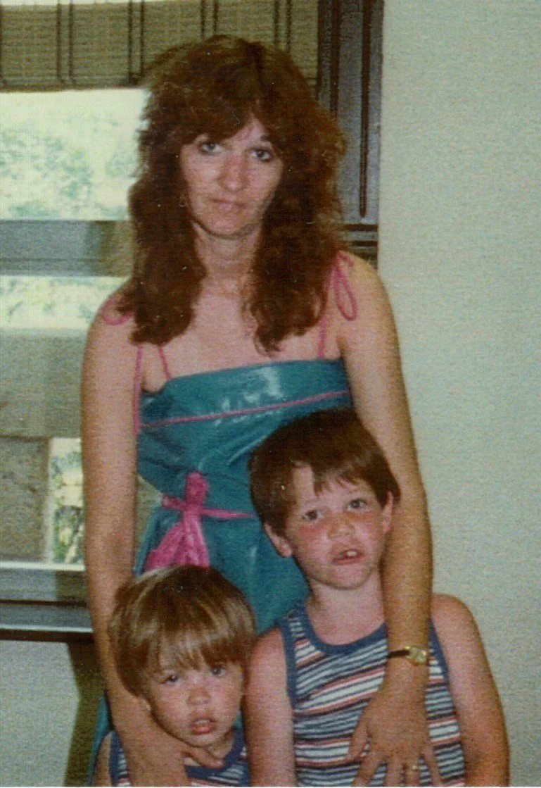 The brothers with their biolgical mother on their adoption day.