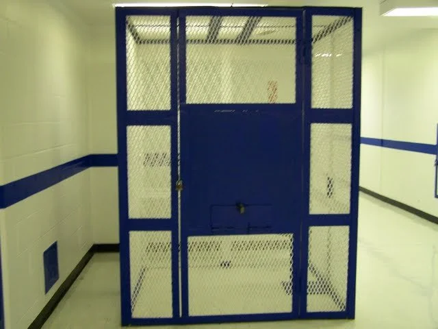 Cage to hold inmates. This is an interesting contraption. It serves a few purposes. If medical needs to draw, but to do so requires removal of handcuffs, they will place you in this cage so that a nurse can securely take blood. Mostly, though, this c