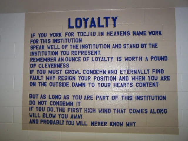 Loyalty sign. Never seen this sign before, so this is clearly the officer break room. Reading it gives me the heebie jeebies. It's like something out of a war movie. It might as just say, "Kill yourself if you betray the state." Who authored this? A 