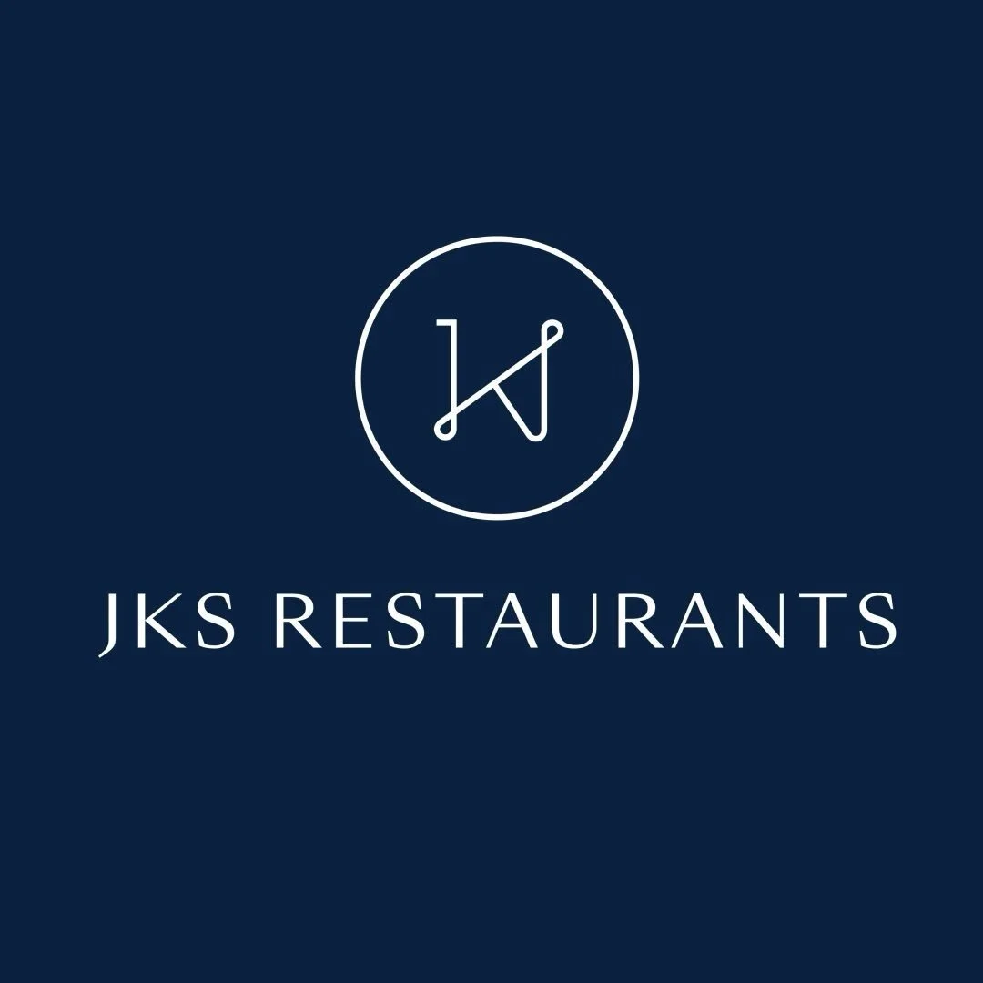 Logo for JKS Restaurants featuring a circular emblem with stylized initials and the restaurant name below on a navy background.
