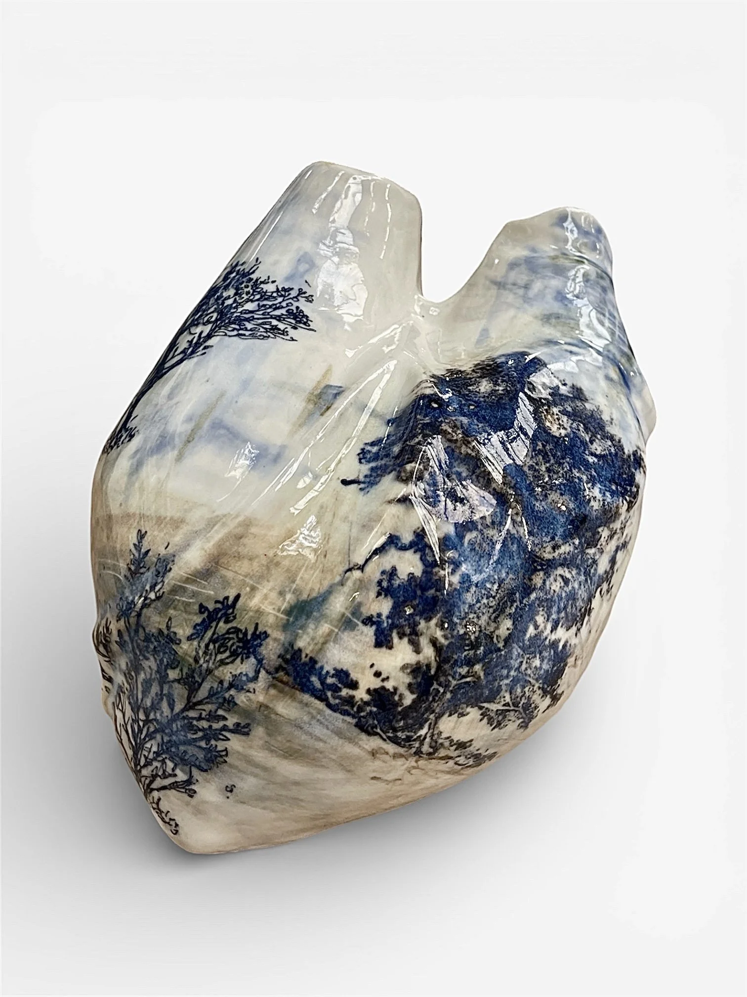 Ceramic vase with landscape design featuring trees in blue, glazed with a glossy finish, on a white background.