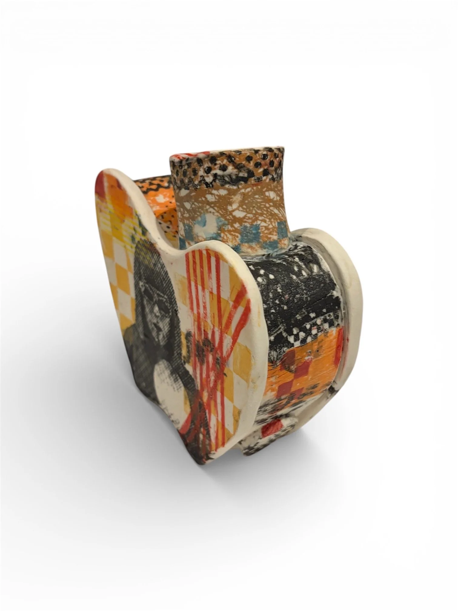Decorative ceramic cup with collage-style artwork featuring abstract patterns and vibrant colors.