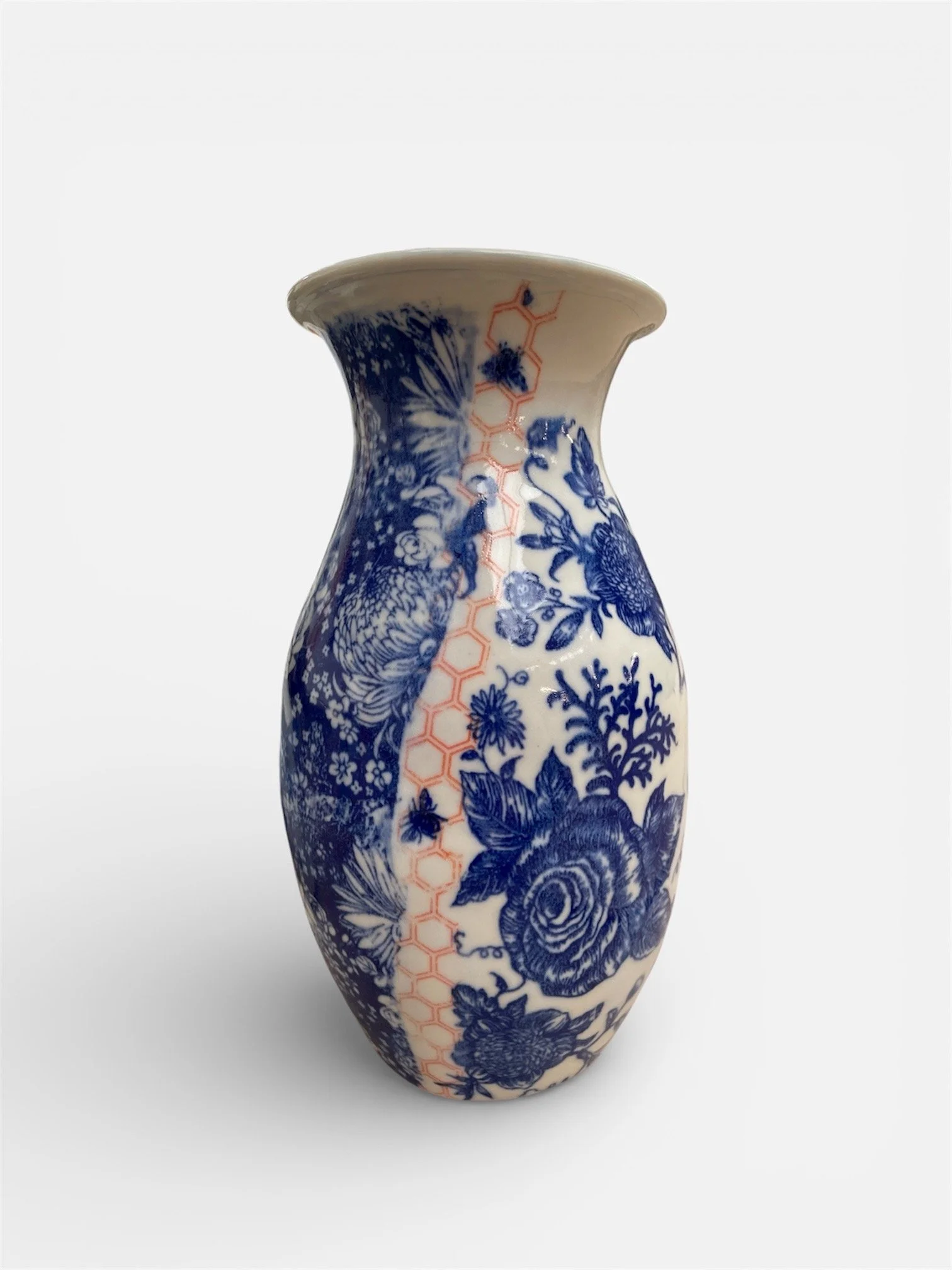 A ceramic vase with a blue and white floral and bird pattern, featuring an orange honeycomb design running vertically.