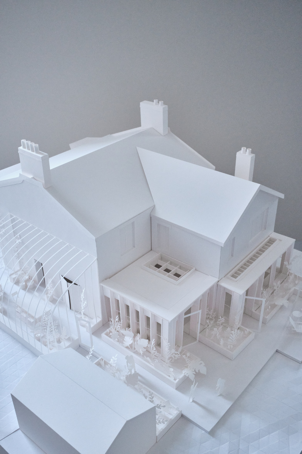 Existing house with a rear extension modelled in great detail in white paper