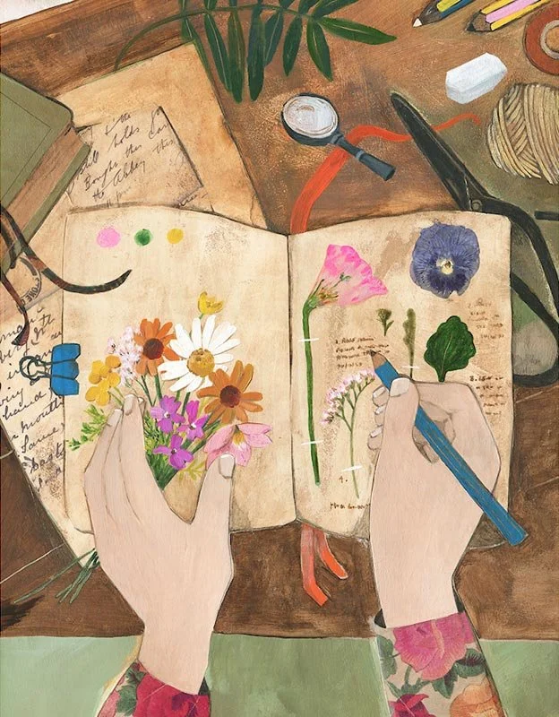 hands holding flowers and writing in a garden journal