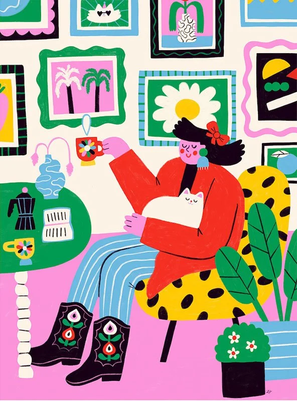 girl on a polka dot chair sipping tea in front of a gallery wall