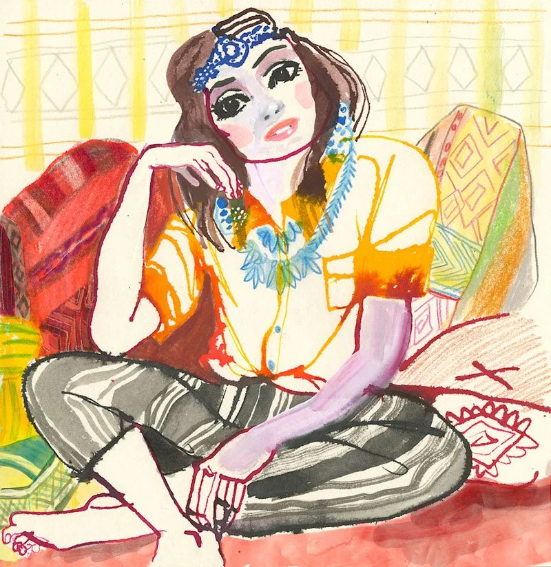 stylist woman sitting in front of a stack of pillows