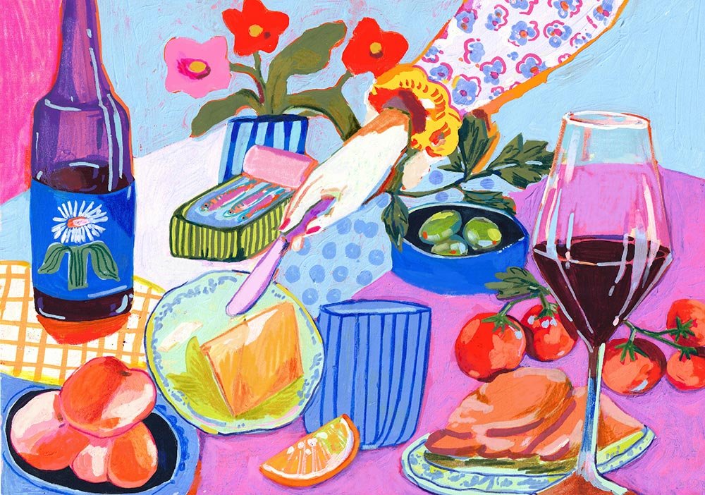 table scene with a wine glass and a hand spreading butter