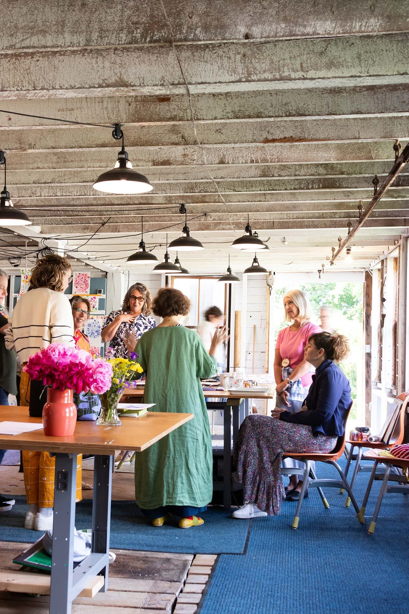 women gathered around a table with art supplies