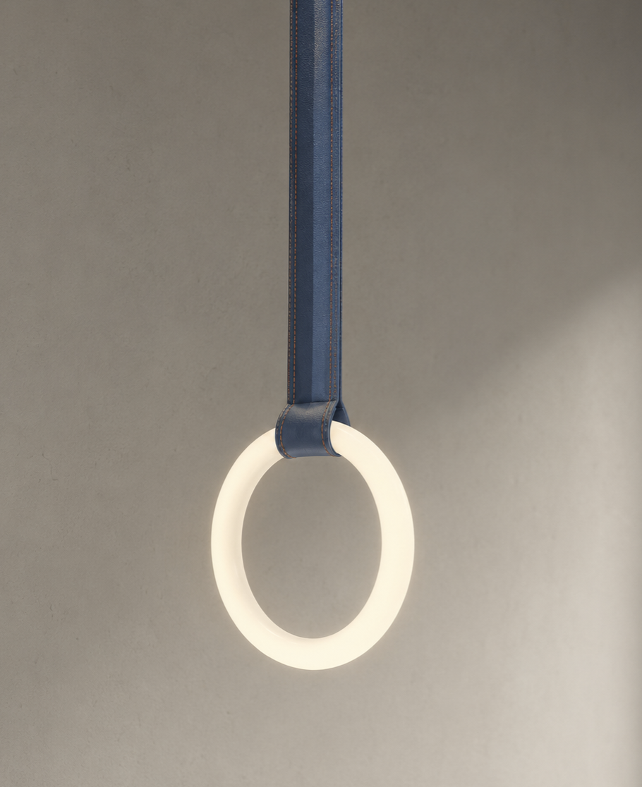 A white ring light attached to a blue strap hanging from above