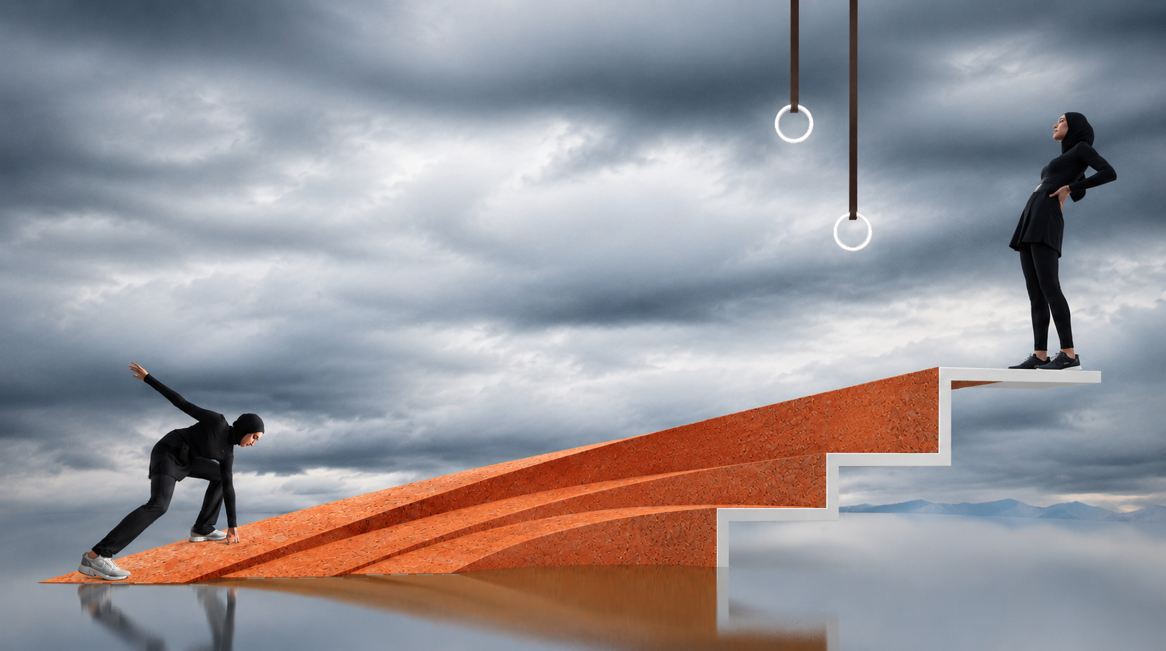 A person in black athletic clothes is at the lower end of a sloped ramp, preparing to climb up. A woman in black athletic clothes and a hijab stands at the top of a stepped platform, looking confident. The background is cloudy and dark, with two gymn