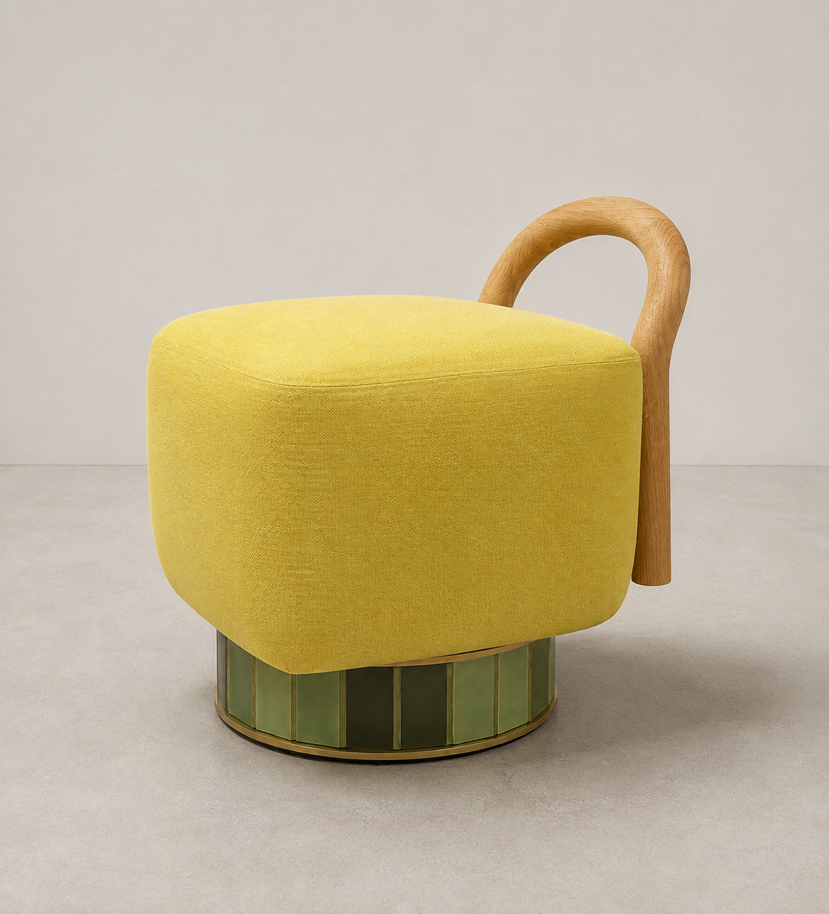 A modern yellow upholstered chair with a curved wooden armrest and a green-tiled circular base, set against a plain background.