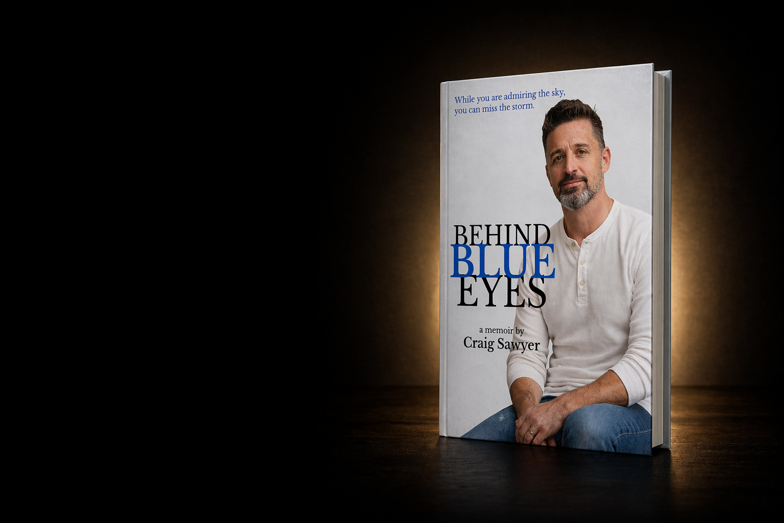 Behind Blue Eyes memoir by Craig Sawyer displayed on a dark stage-style background.