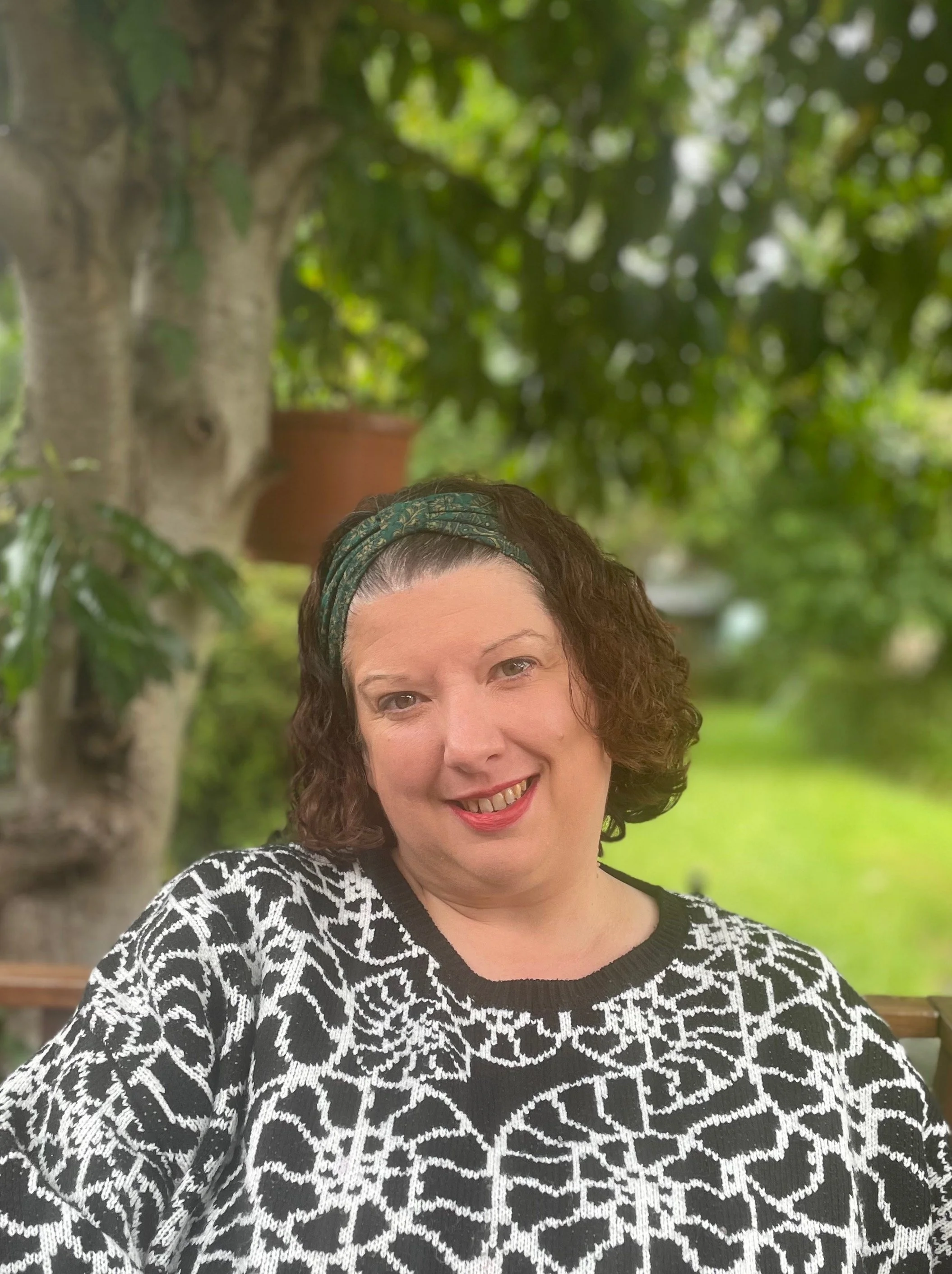 Beth Roberts, trauma-informed counsellor in Oxford smiling beneath a tree
