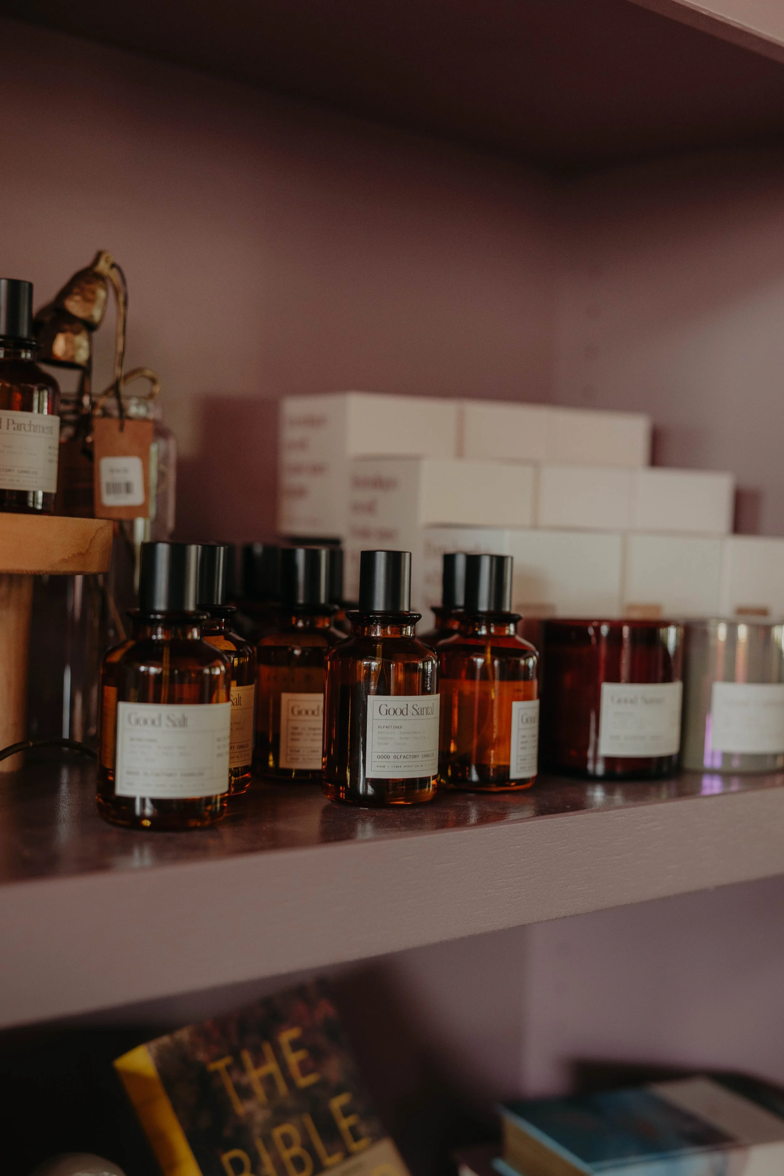 Shelf with small amber glass bottles labeled 'Good Salt' and white boxes behind them.
