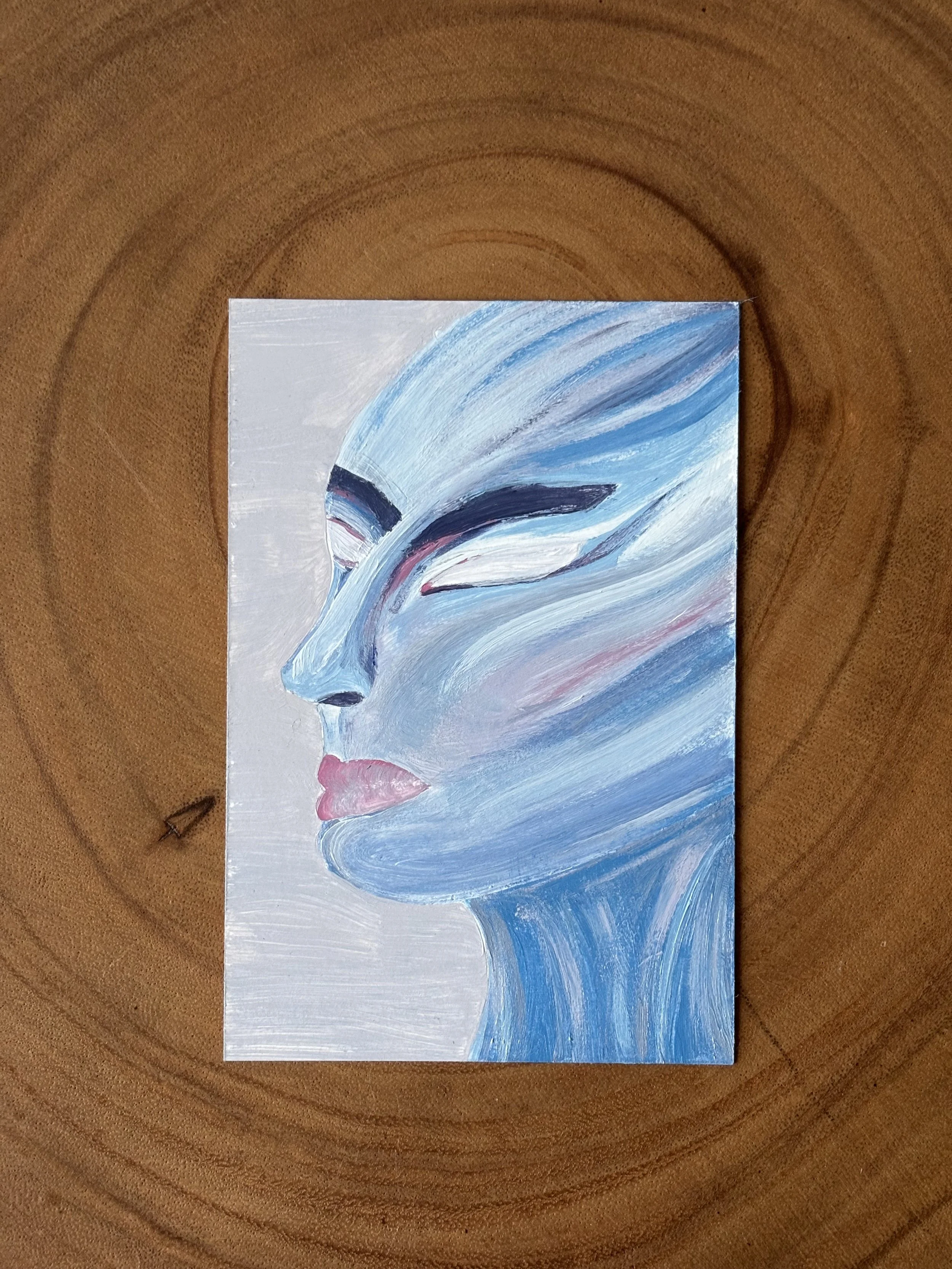 Abstract painting of a woman's face with white eyes, made up of flowing lines in shades of blue, white, and pink.
