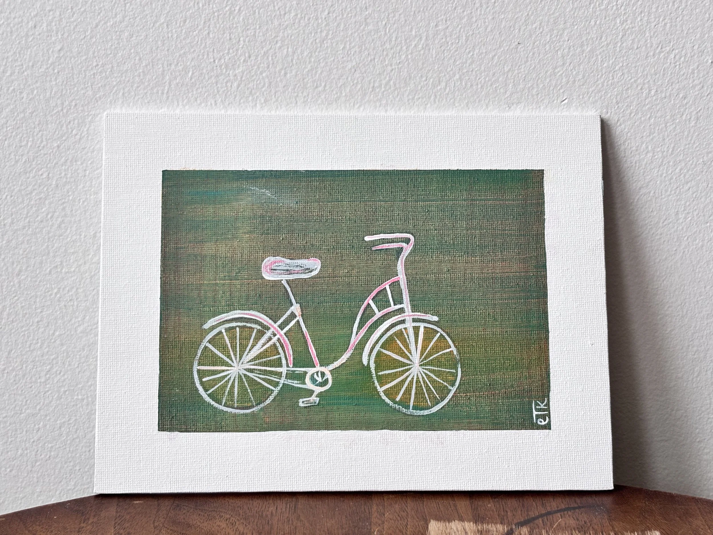 Acrylic painting on white canvas of a pink and white bicycle on a green textured background.
