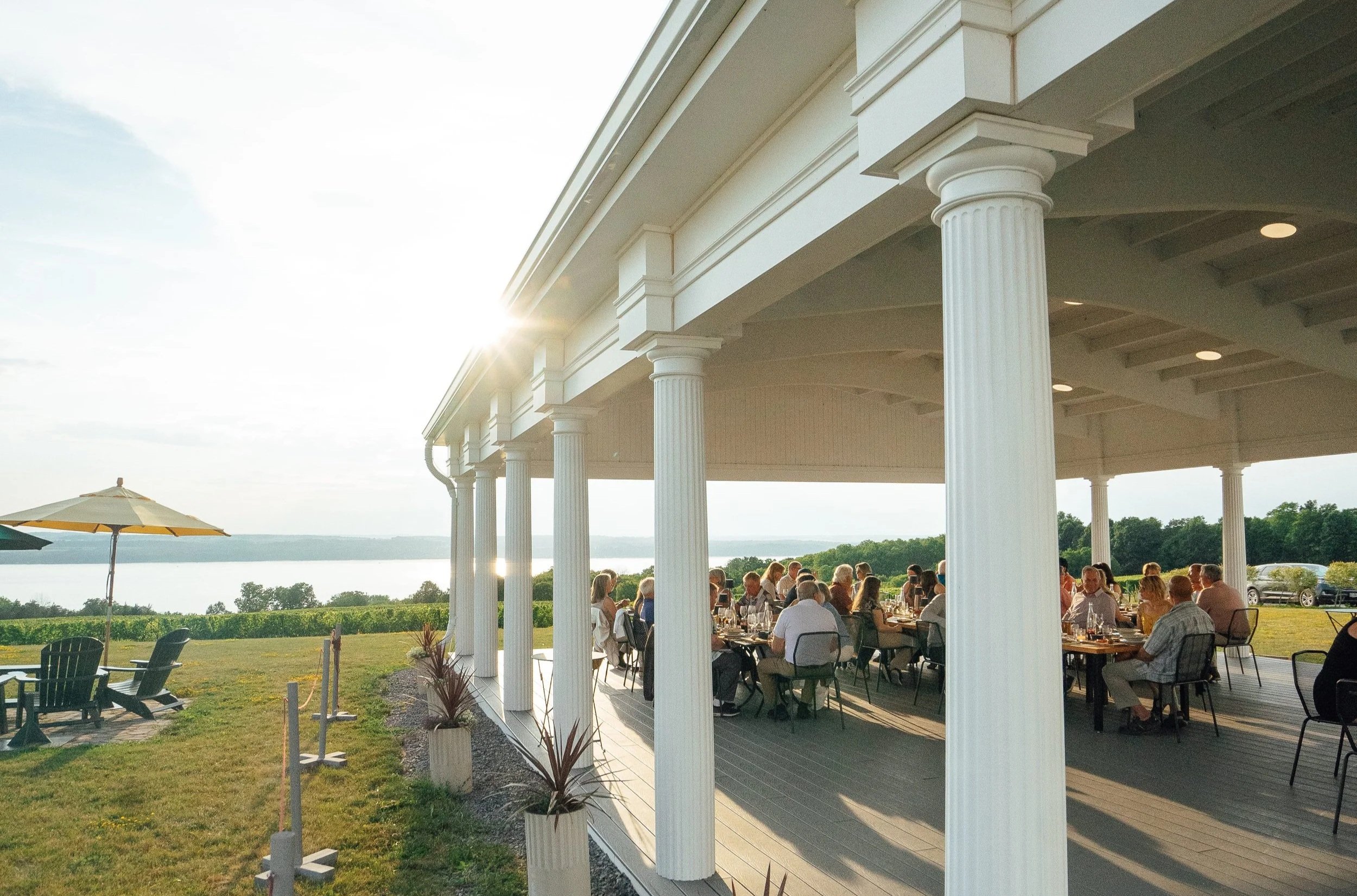 Guests seated at a dinner facing the lake