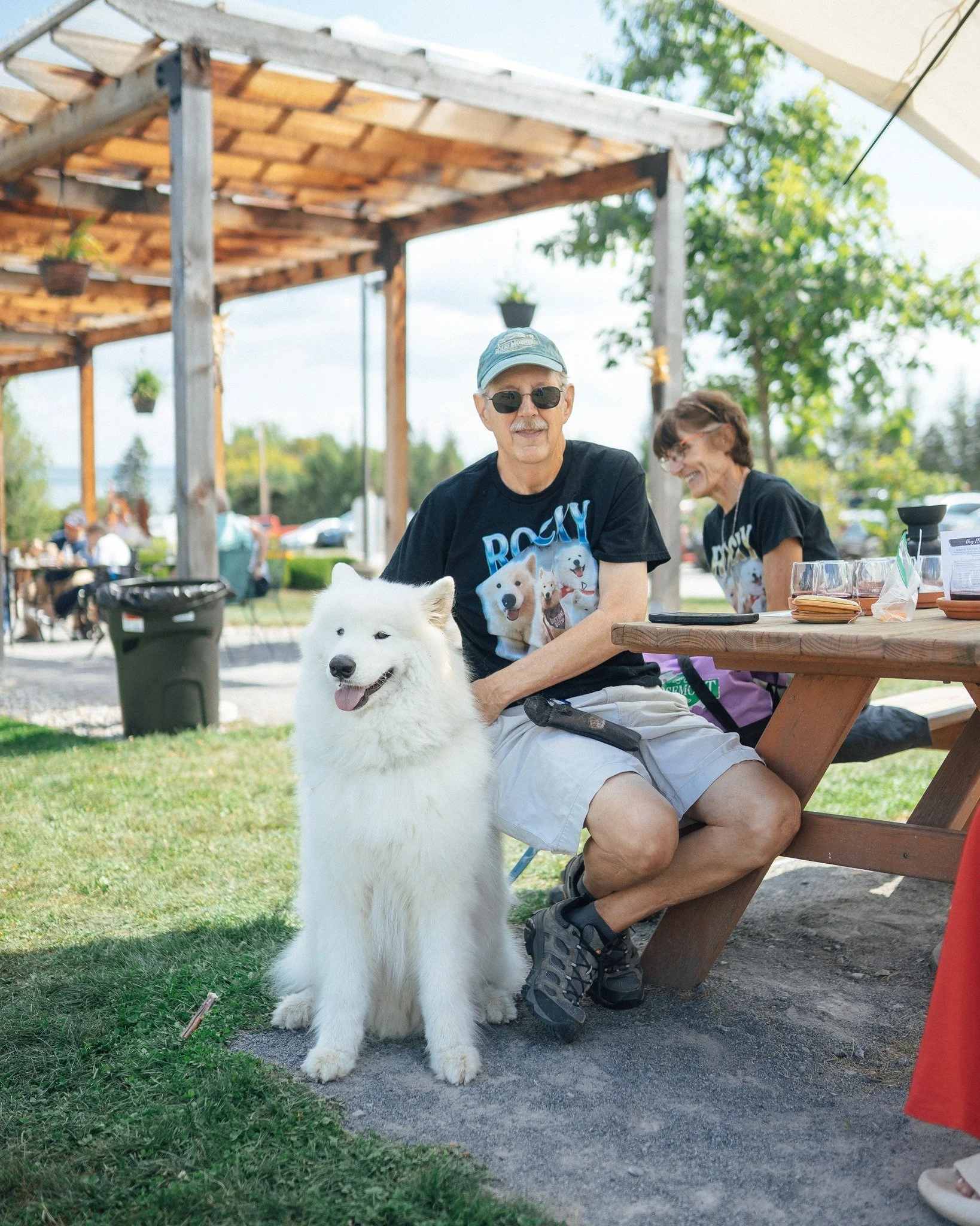 man and his dog at picnic table