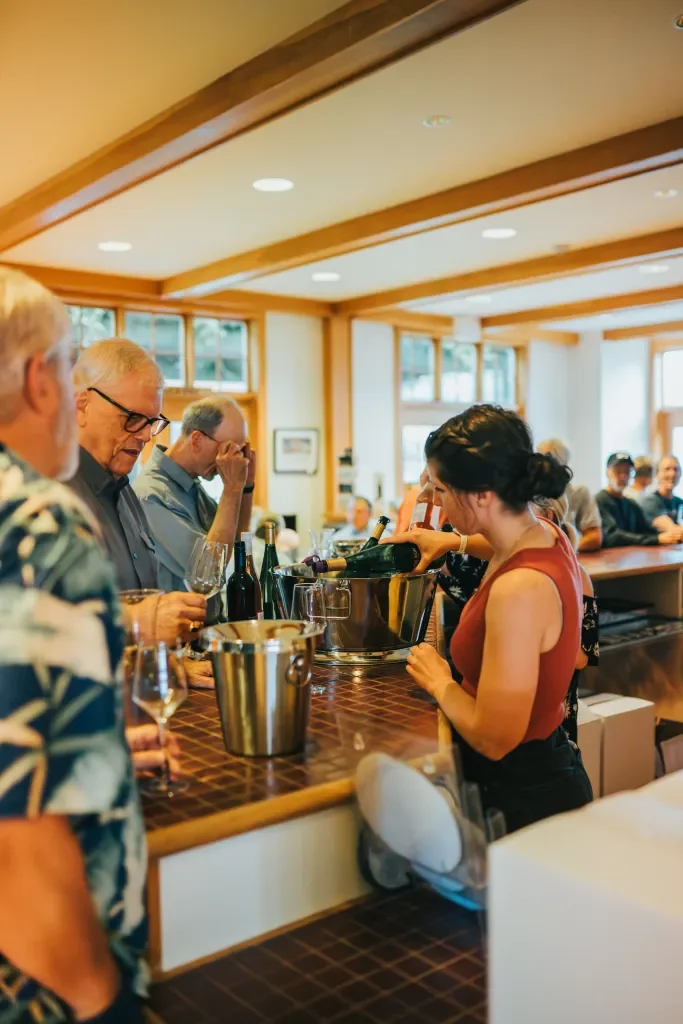bartender pouring glass of wine in tasting room