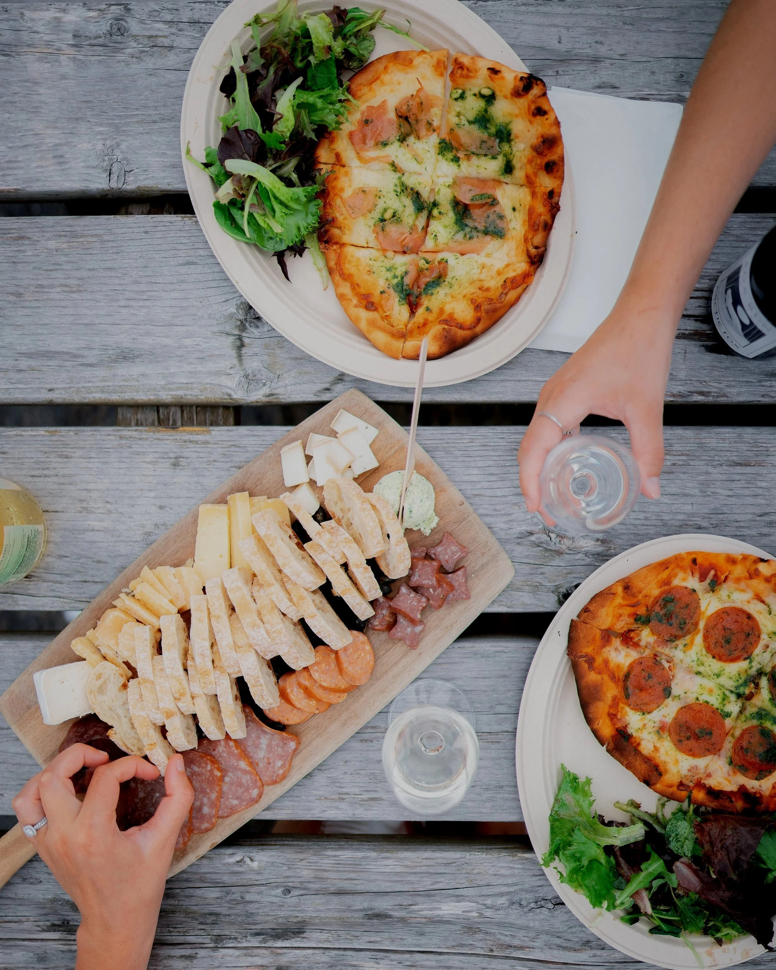 food on table with glasses of wine