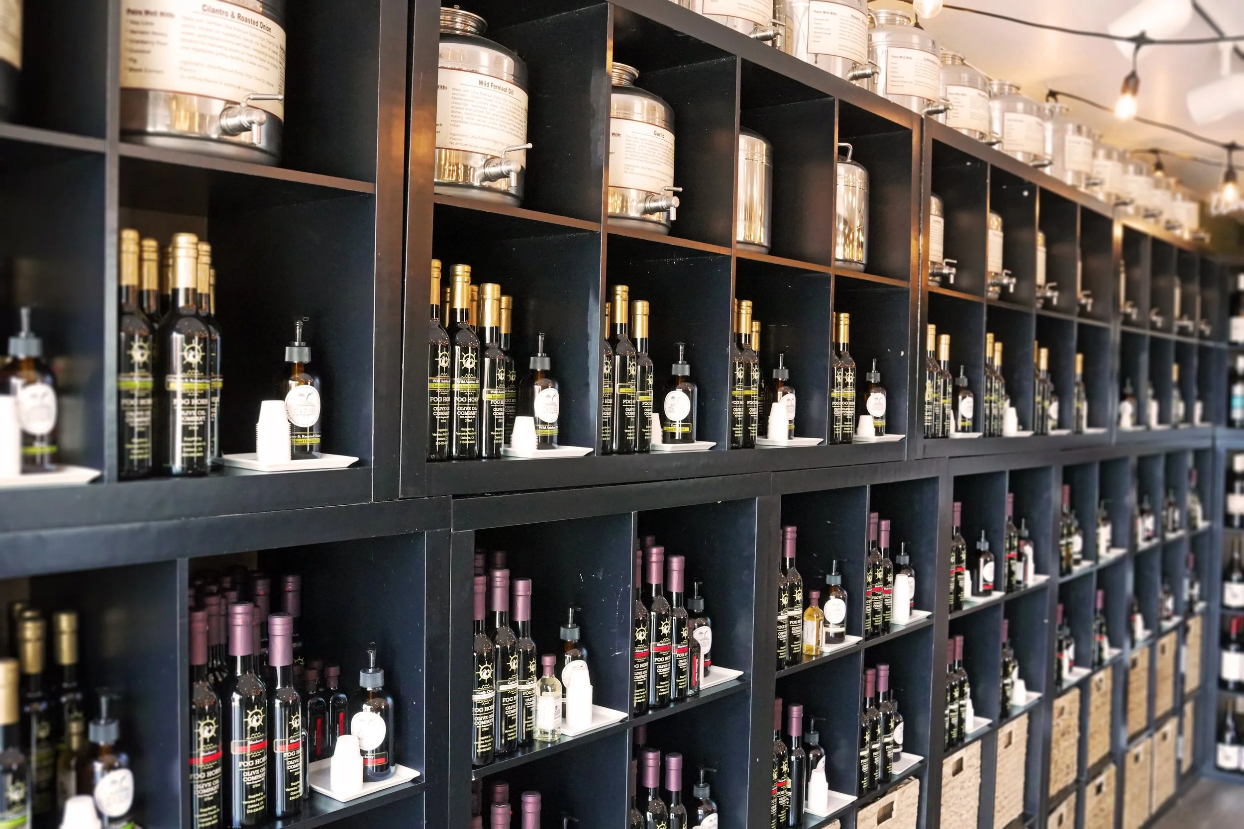 Fog Horn Tasting Room olive oil and balsamic bottles on their shelf display