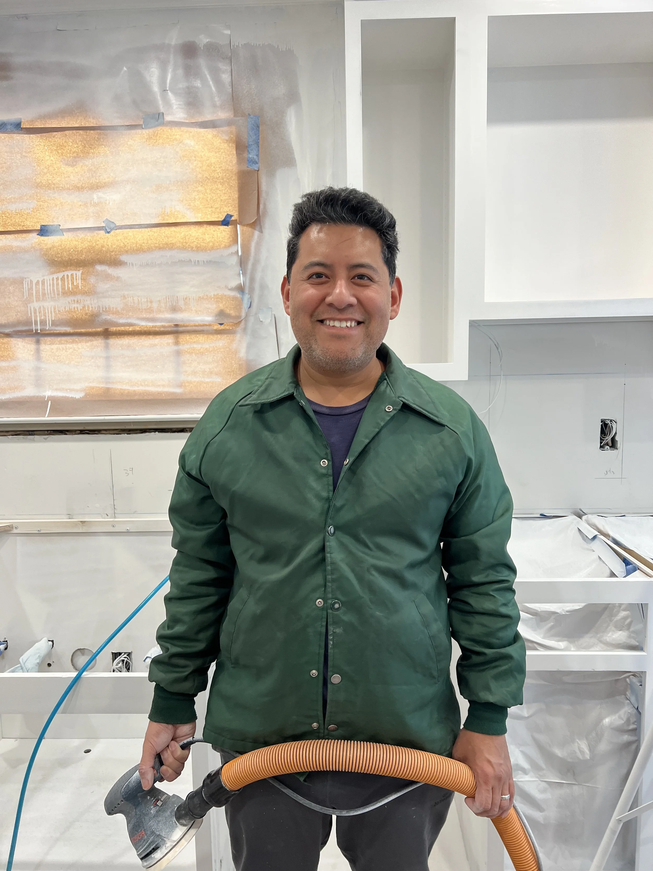 Handyman holding a power sander during a renovation project