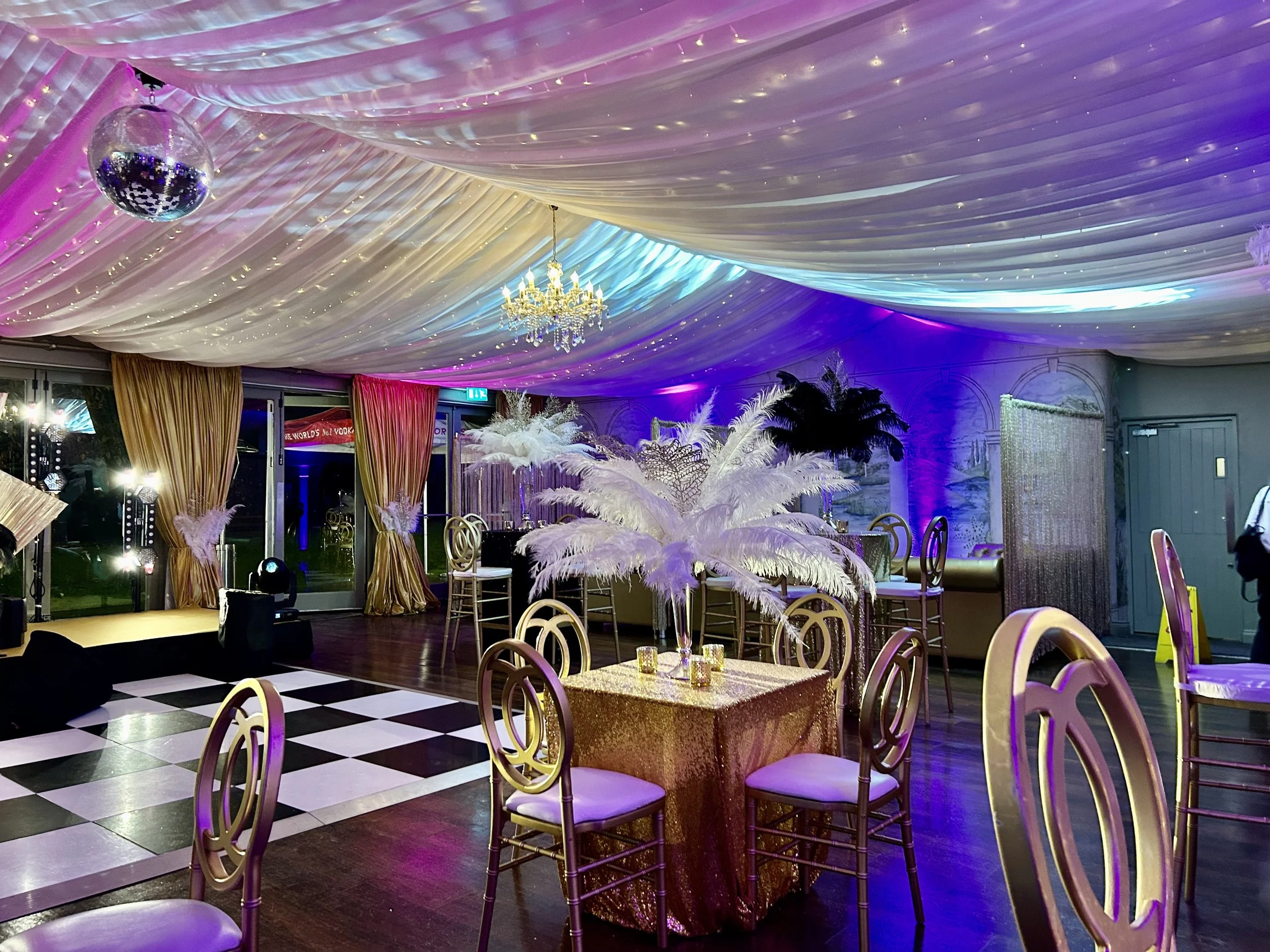 Large plume feather centrepieces adore a party table