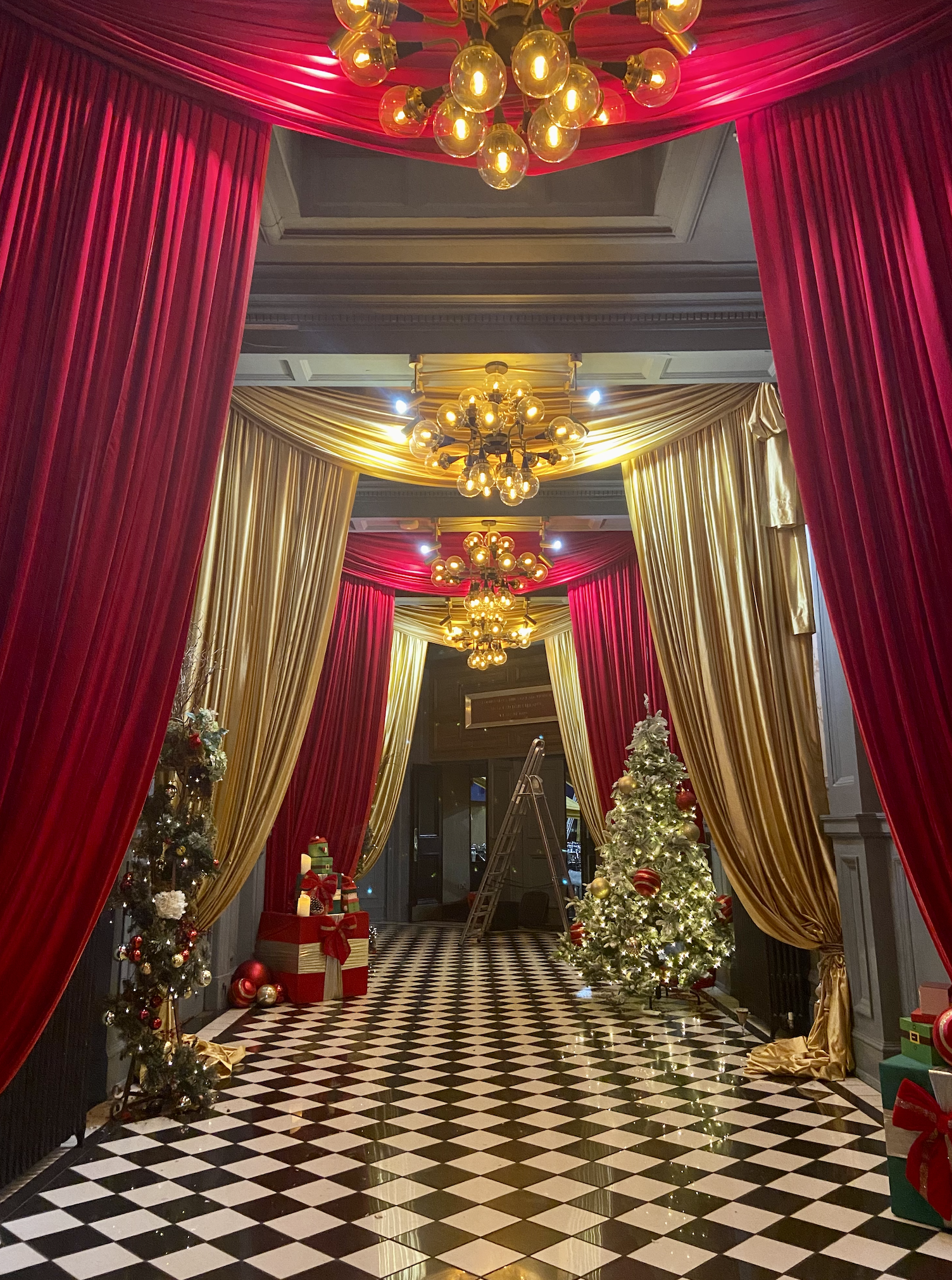 This image captures a luxurious Christmas corridor styled like a festive stage set.