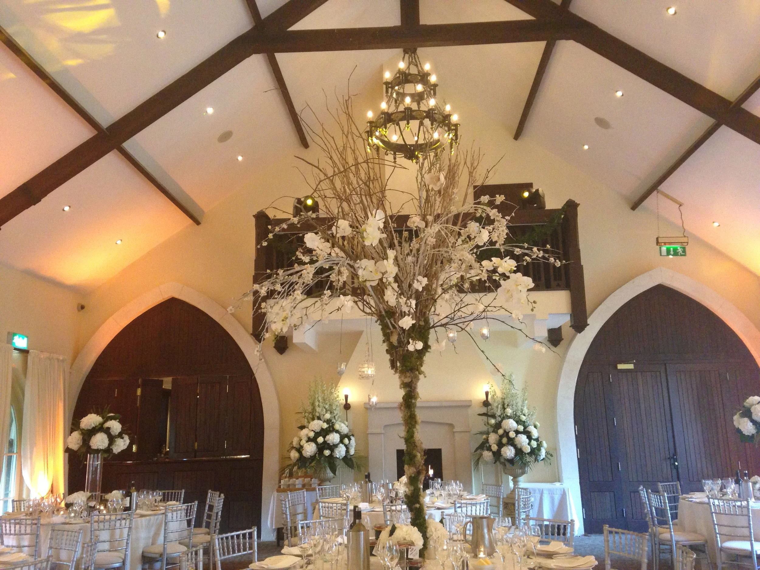 Wedding decor in The Brook Lodge with white florals and tree tables