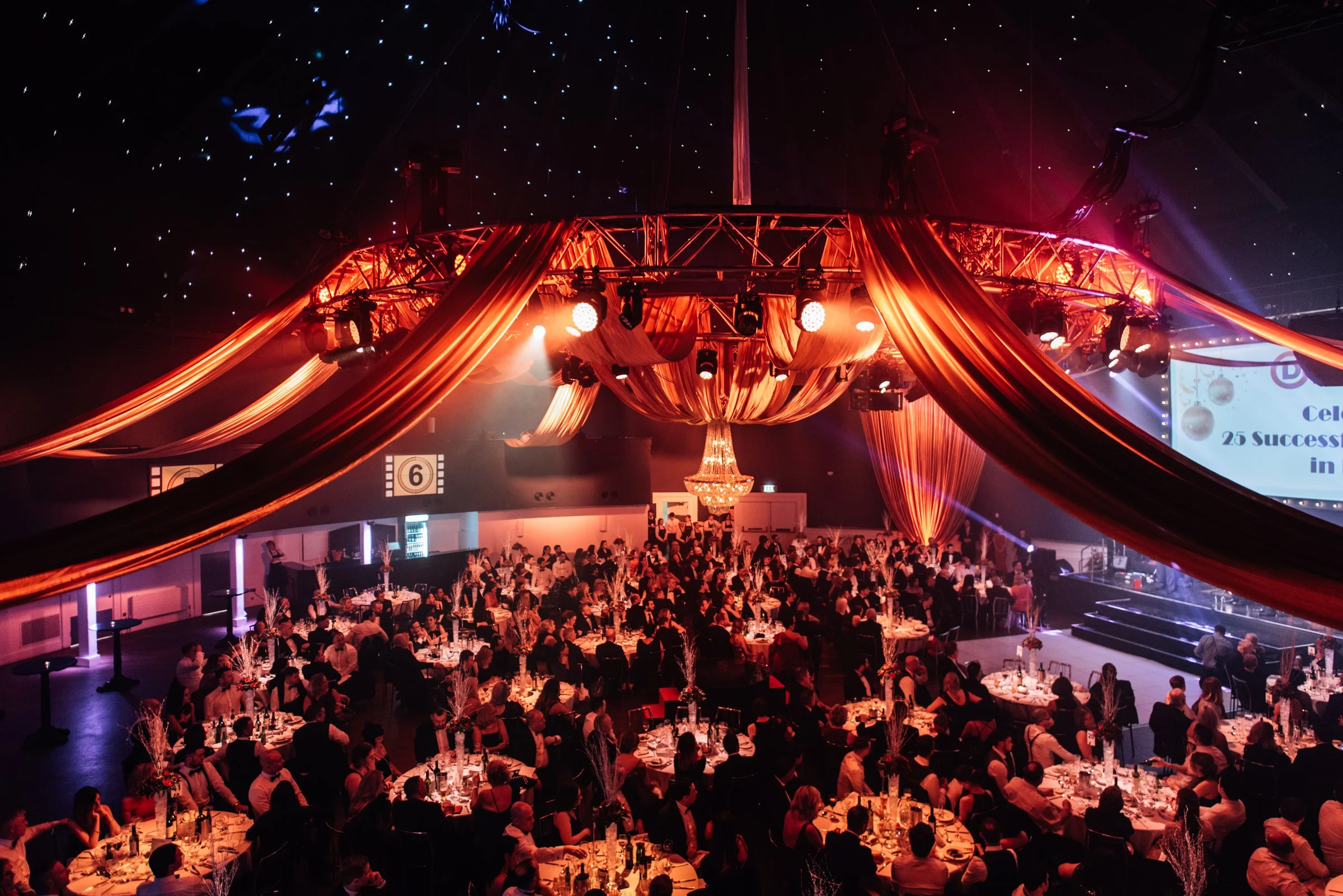 A Gatsby party with gold fabric draping to enhance a New Years Eve Party