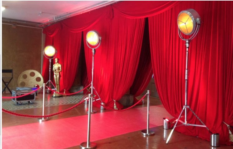Red carpet entrance with red curtains and stage lighting