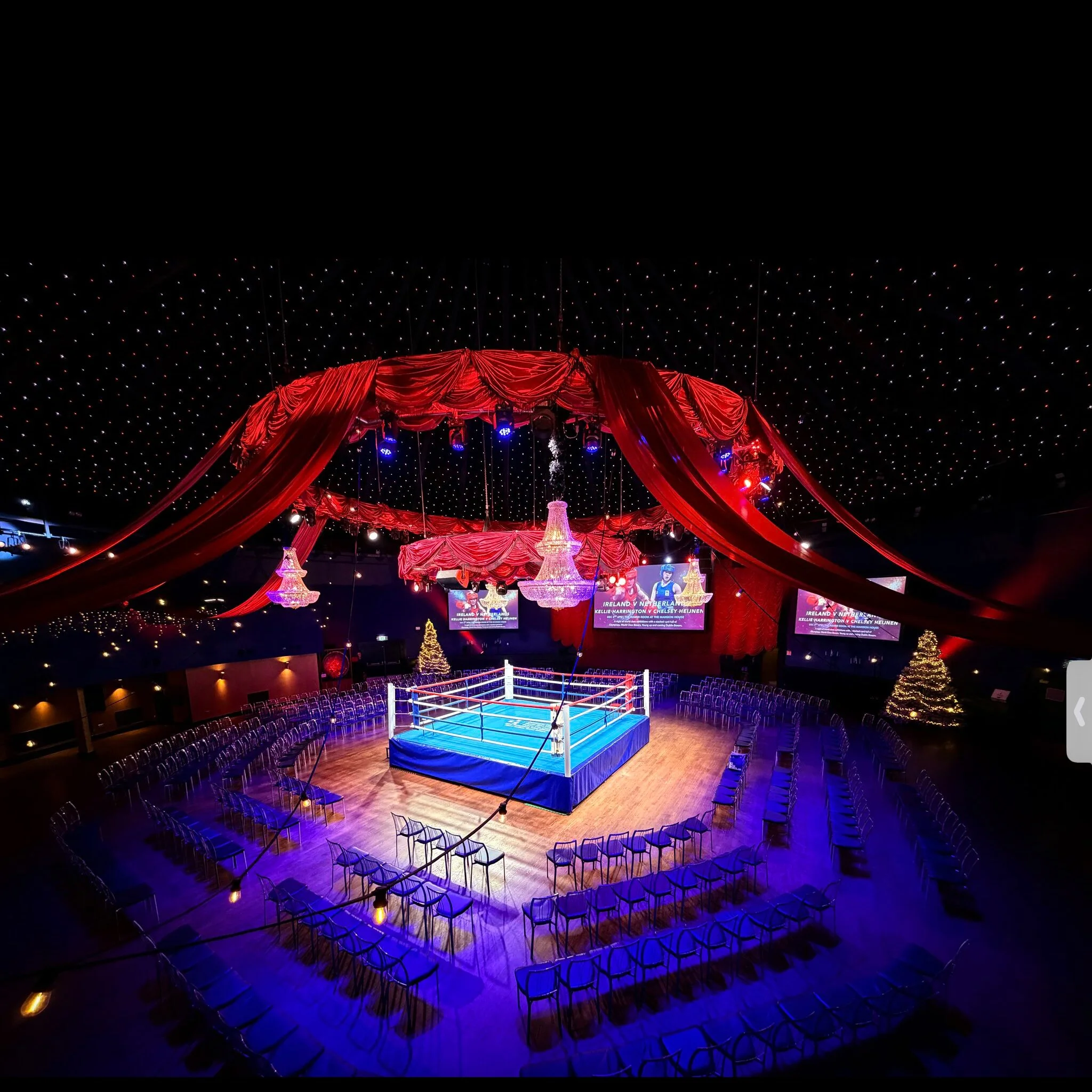 The surrounding darkness, dotted with tiny points of light, makes the chandelier feel almost celestial—grand, theatrical, and slightly surreal.