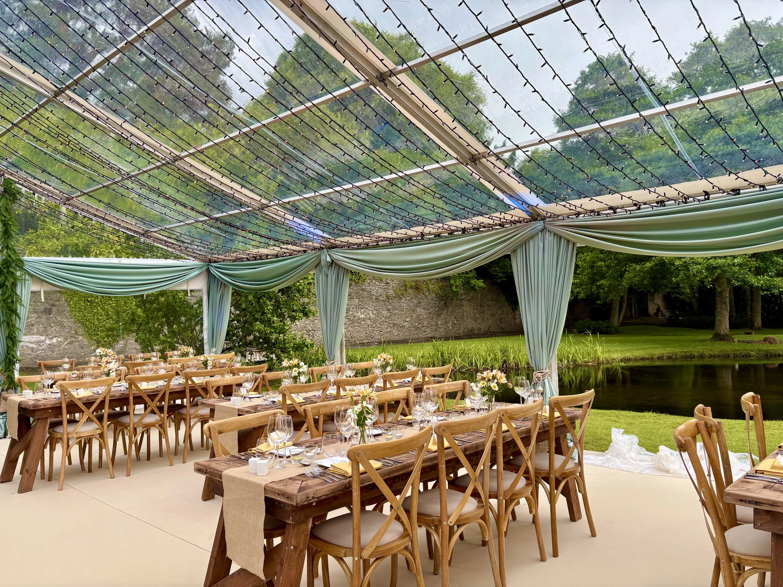This image captures a serene, light‑filled reception space overlooking a peaceful lakeside view.