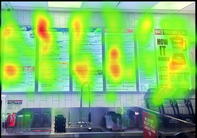Heatmap of a menu board inside a restaurant or cafe with areas of high attention marked in red, medium in yellow, and low in green, showing where customers focus.