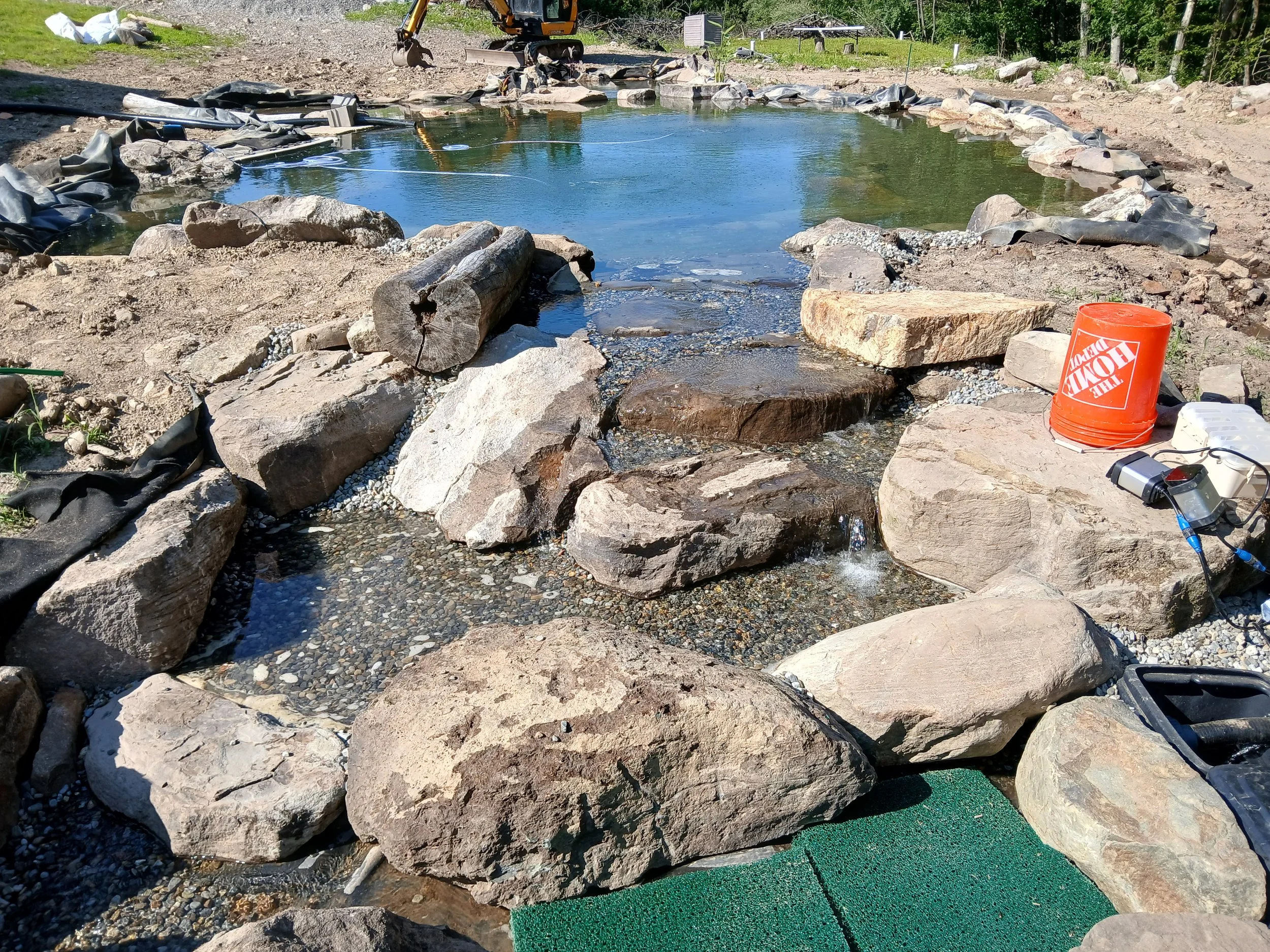 Koi pond with a negative edge / infinity pool edge leading to reservoir