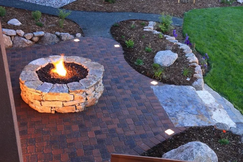 Fire pit and paver patio by Luck Lagoons Landscaping