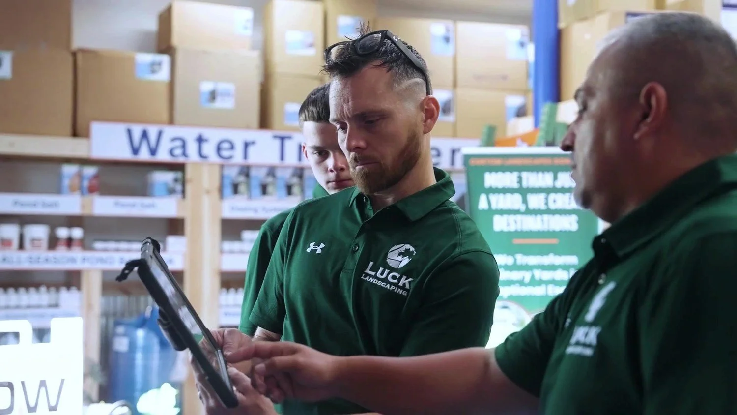 Luck Lagoons team members reviewing a design on a tablet