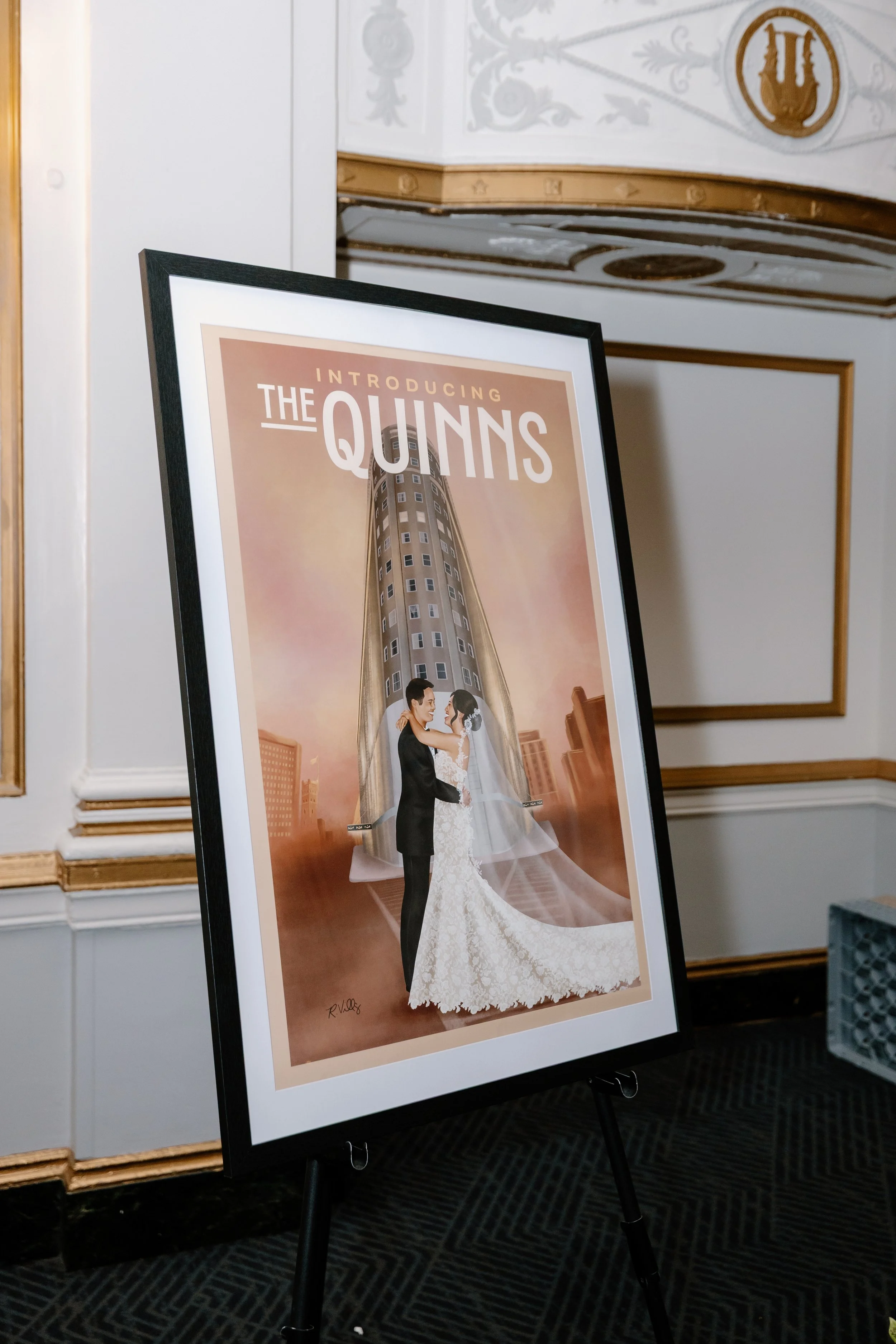 Illustration of a wedding couple in front of a tall building with the text 'Introducing The Quinns'.
