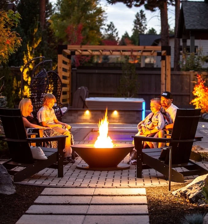 Family around a fire roasting marshmellows in Tethero resort commercial photos in Bend Oregon.