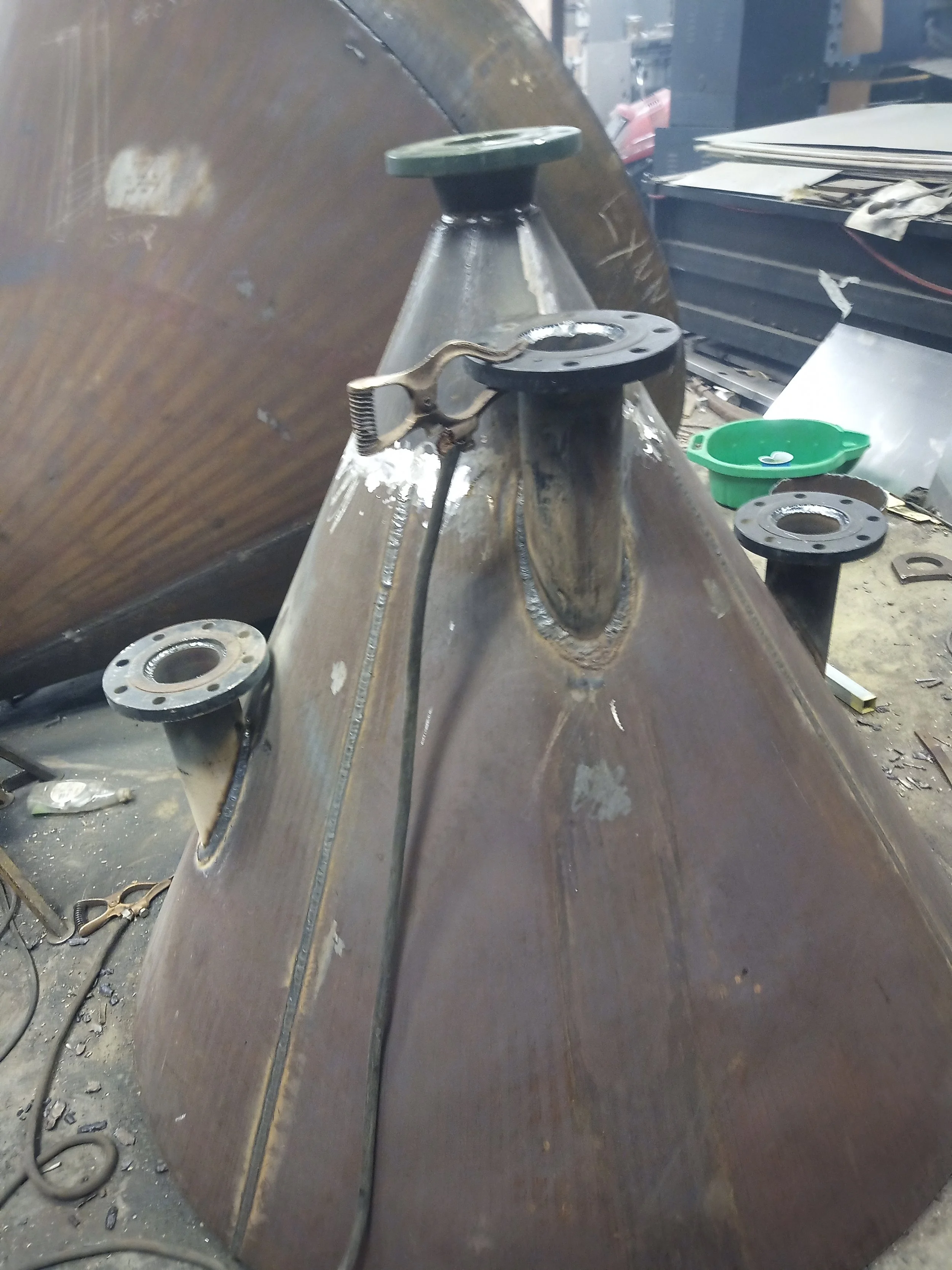 A custom carbon steel pressure vessel cone fitted with flanged nozzles, engineered and welded to ASME BPVC Section VIII specifications