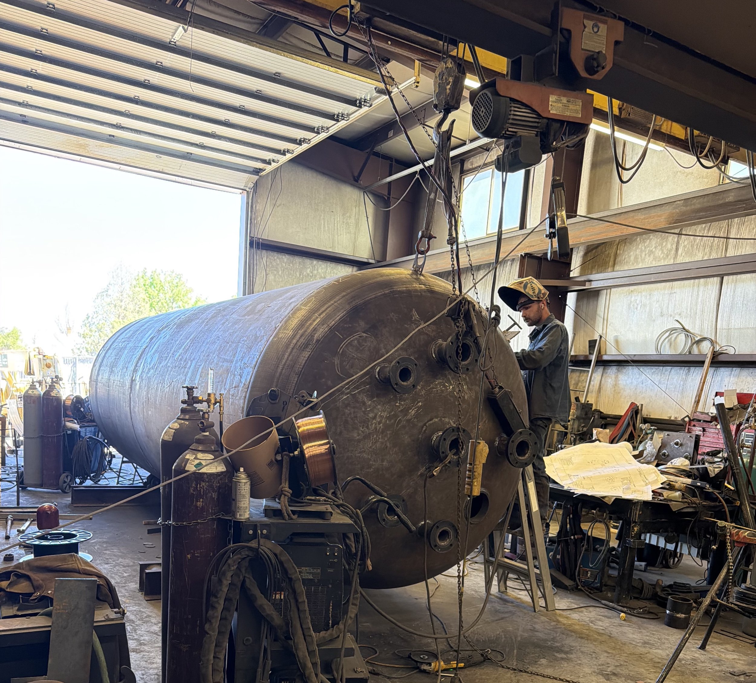A Peak Welding fabricator working on a heavy-duty carbon steel ASME pressure vessel inside the Utah manufacturing facility.