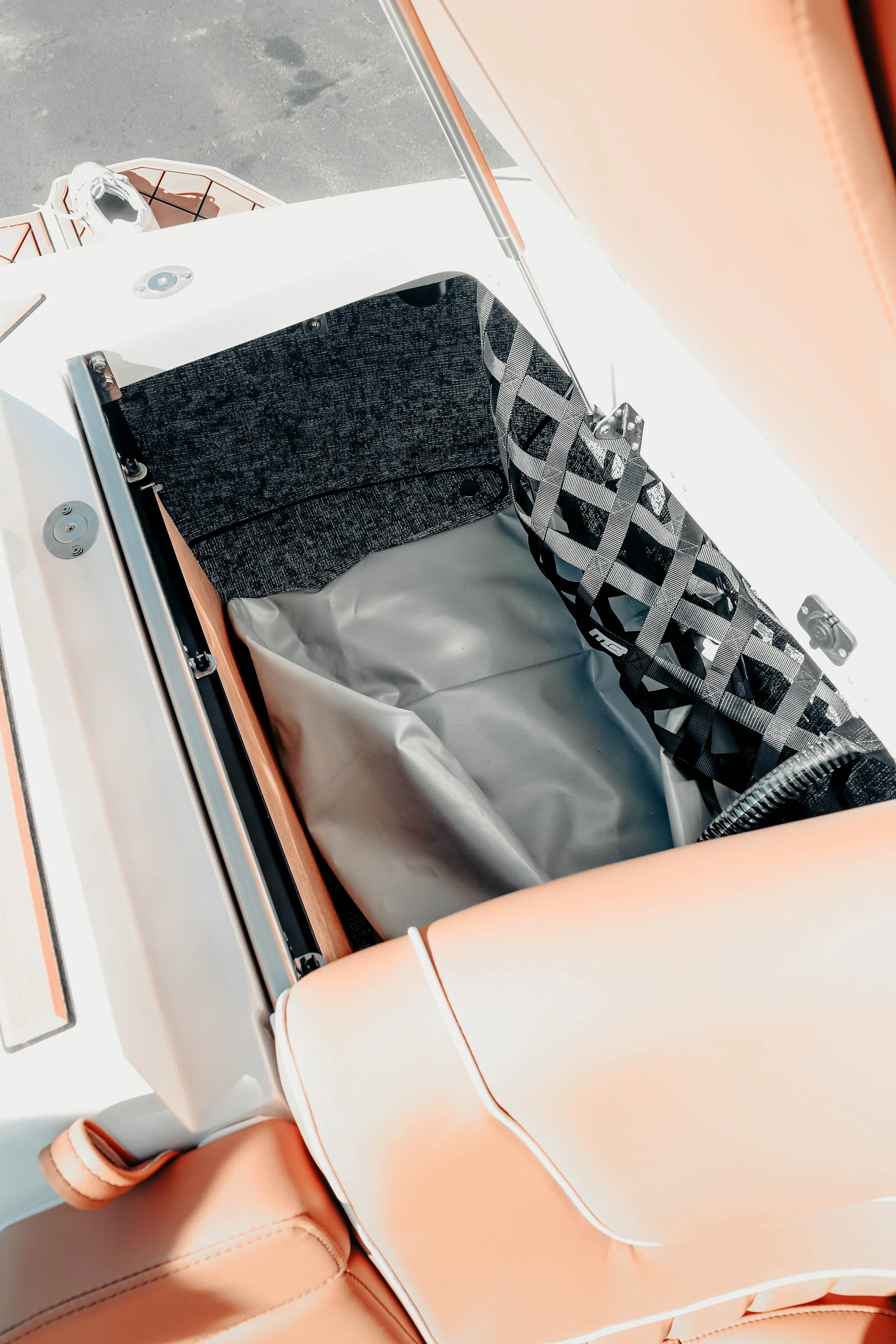 Interior view of a spacecraft or aerospace vehicle with a padded seat, safety straps, and equipment.