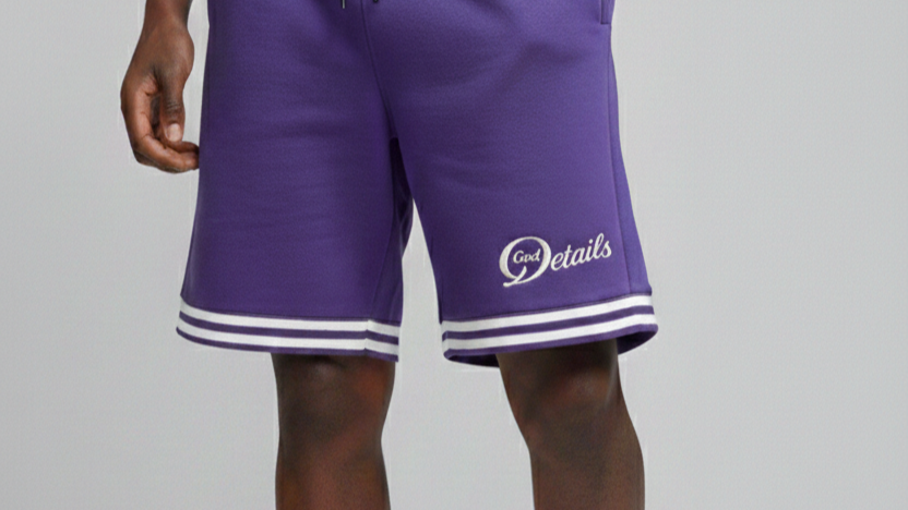 Purple athletic shorts with white stripes and the logo 'Good Details' on the left leg.